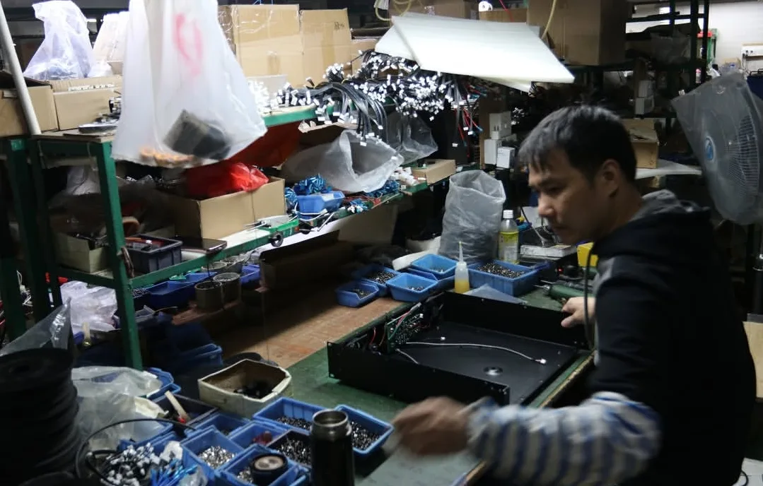 High-Current Amplifier Chassis Wiring & Internal Hardware Assembly Assembly technician wiring internal chassis components, transformer mounts, and circuit boards of an ELM Audio high-power amplifier