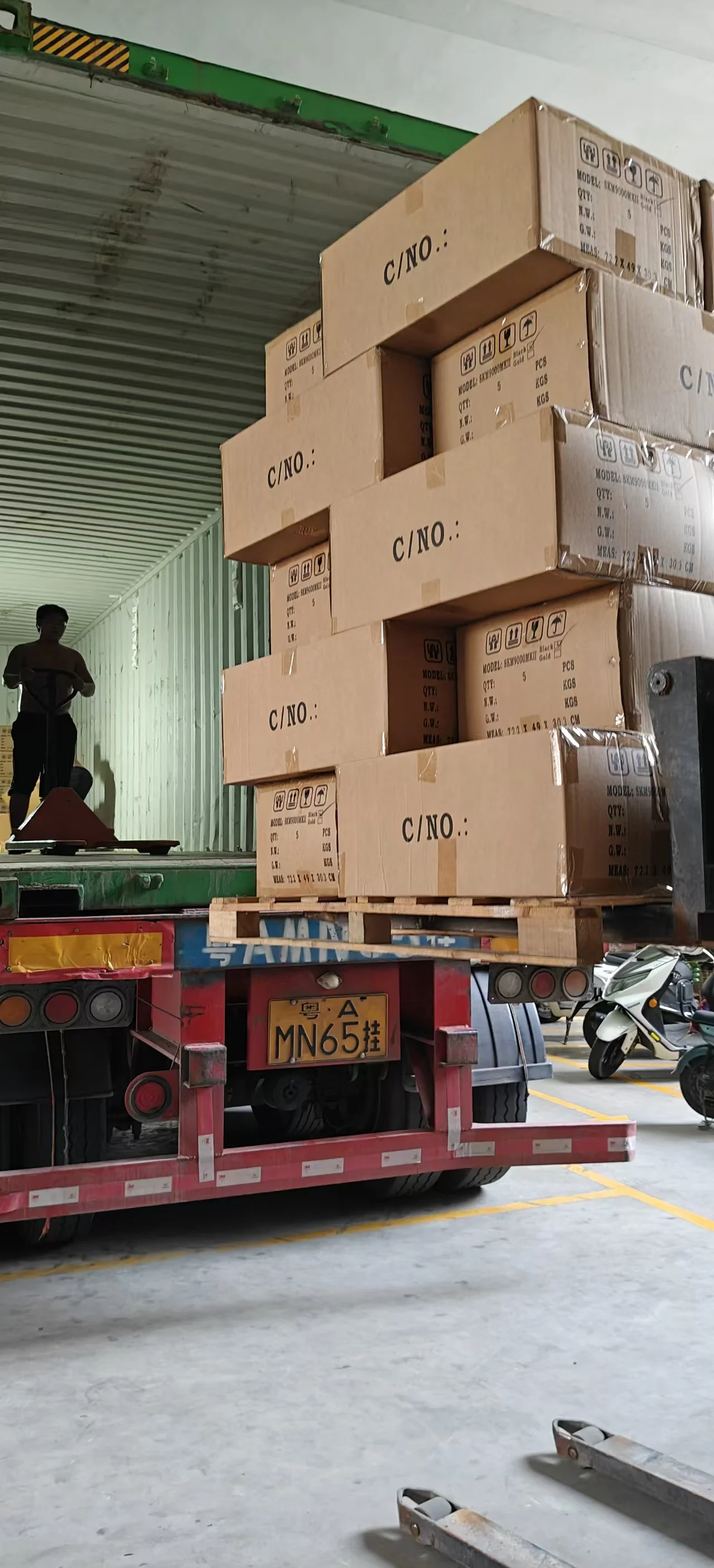 Global Export Loading · Heavy Duty Pallet Container Dispatch Heavy truck loading high-stacked ELM Audio export cartons with forklift into shipping container with Guangdong license plate Yue A MN65